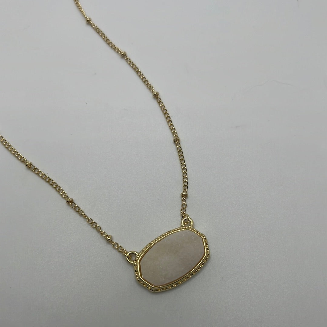 Gold chain necklace with white pendant