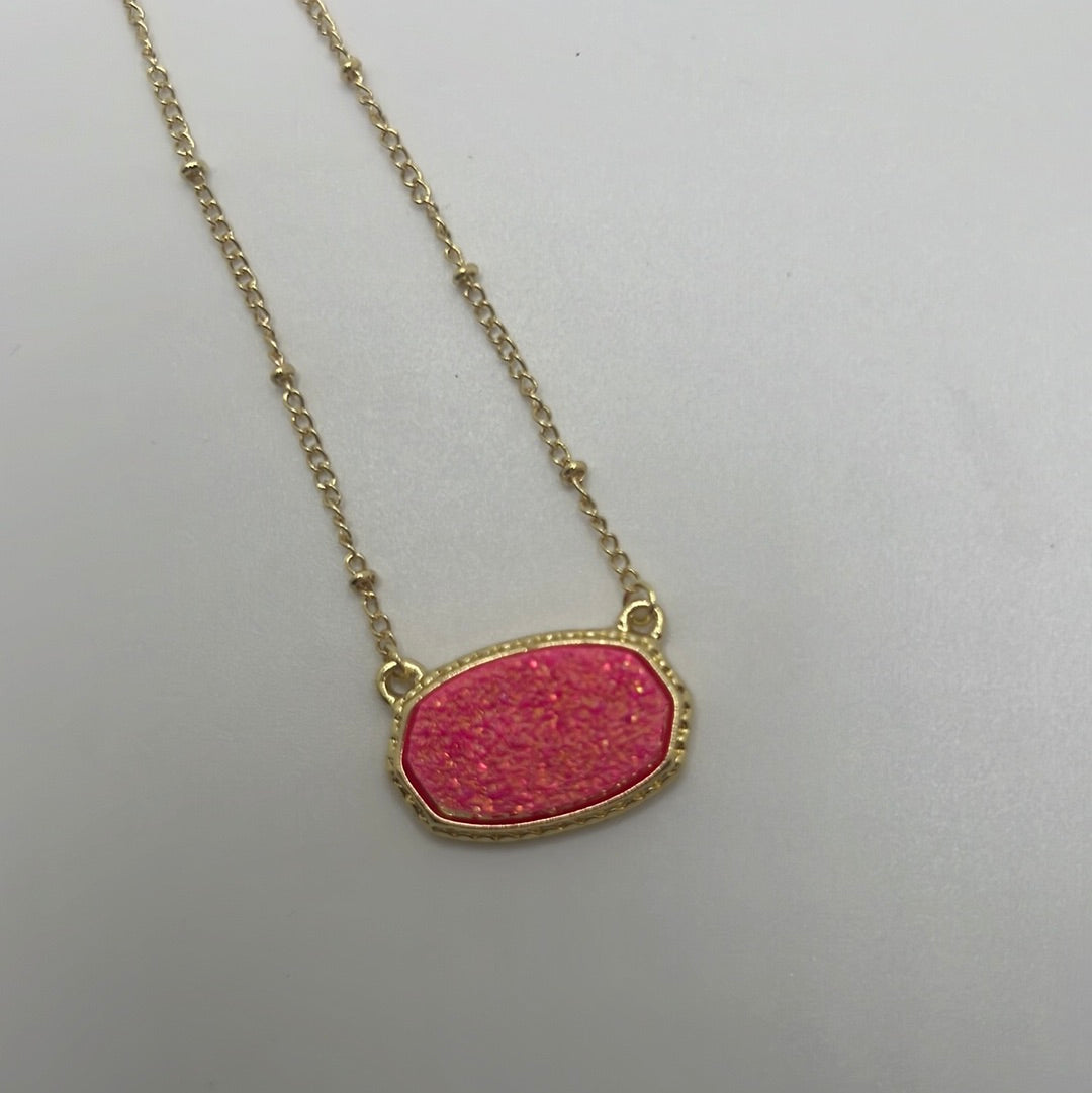 Gold chained necklace with pink pendant